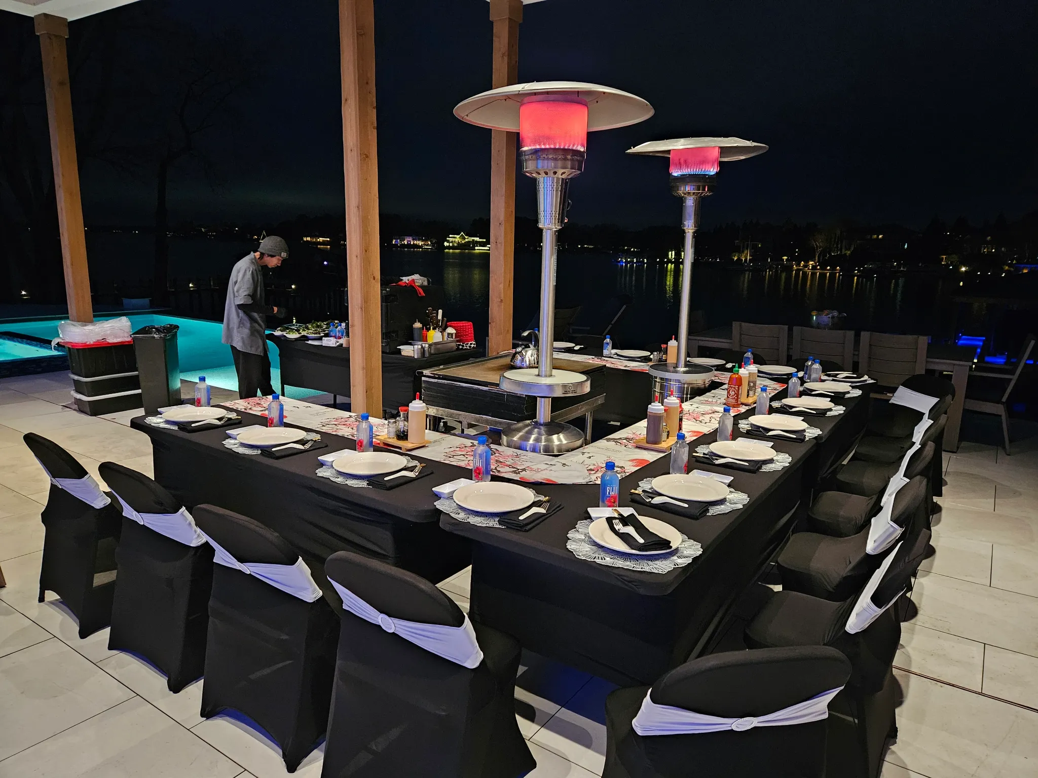 Two outdoor heaters beside a private teppanyaki event setup